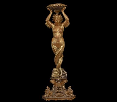 Large carved and gilded wooden sculpture depicting a siren supporting a vessel