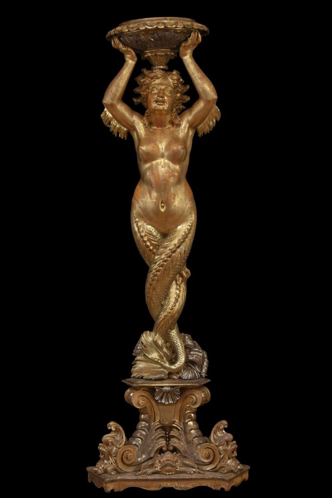 Large carved and gilded wooden sculpture depicting a siren supporting a vessel