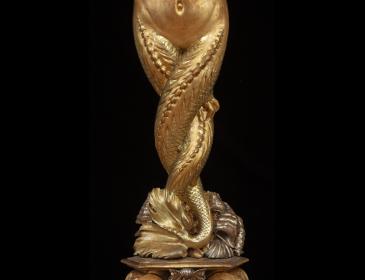 Large carved and gilded wooden sculpture depicting a siren supporting a vessel
