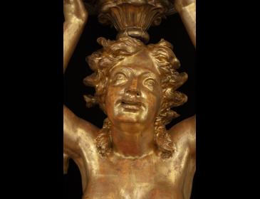 Large carved and gilded wooden sculpture depicting a siren supporting a vessel