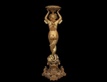 Large carved and gilded wooden sculpture depicting a siren supporting a vessel