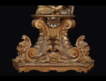 Large carved and gilded wooden sculpture depicting a siren supporting a vessel
