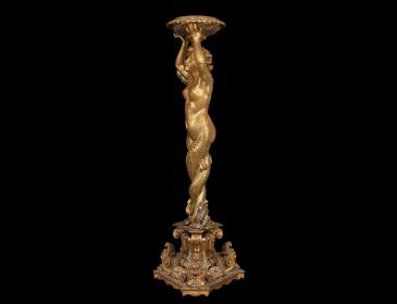 Large carved and gilded wooden sculpture depicting a siren supporting a vessel