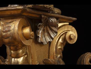 Large carved and gilded wooden sculpture depicting a siren supporting a vessel