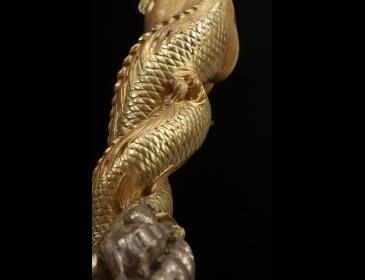 Large carved and gilded wooden sculpture depicting a siren supporting a vessel