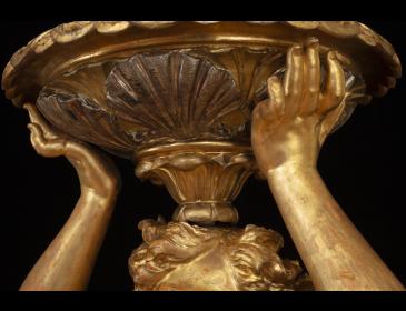 Large carved and gilded wooden sculpture depicting a siren supporting a vessel